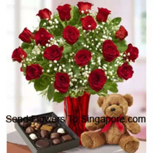 24 Red Roses With Some Ferns In A Glass Vase, A Cute Brown Teddy Bear And An Imported Box Of Chocolates