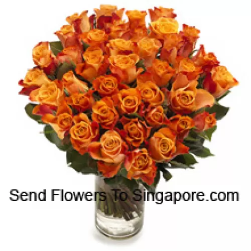 50 Orange Roses With Seasonal Fillers In A Glass Vase